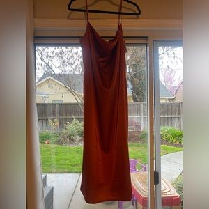Spaghetti strap satin midi dress in burnt orange. Also selling emerald green
